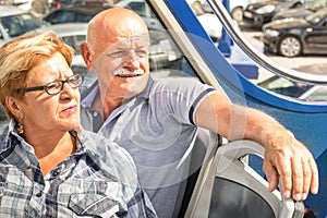 Happy senior couple in travel moment on sightseeing bus