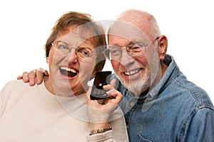 Happy Senior Couple Using Cell Phone on White