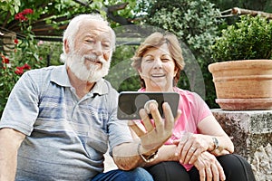 Happy Senior Couple Using A Modern Phone