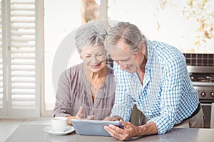 Happy senior couple using tablet