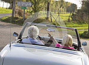 Happy Senior couple in vintage sports car