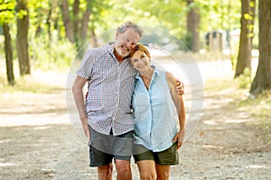 Happy senior couple walking and enjoying life outdoors photo