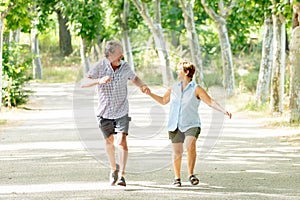 Happy senior couple walking and enjoying life outdoors