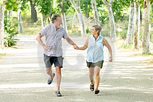 Happy senior couple walking and enjoying life outdoors