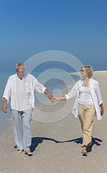 Happy Senior Couple Walking Holding Hands Tropical Beach