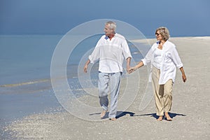 Happy Senior Couple Walking Holding Hands Tropical Beach