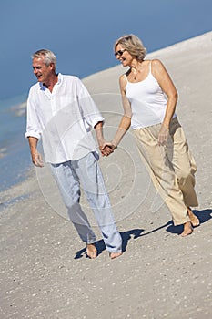 Happy Senior Couple Walking Holding Hands Tropical Beach