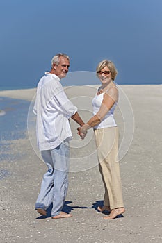 Happy Senior Couple Walking Holding Hands Tropical Beach