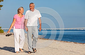 Happy Senior Couple Walking Laughing on a Beach