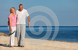 Happy Senior Couple Walking Laughing on a Beach