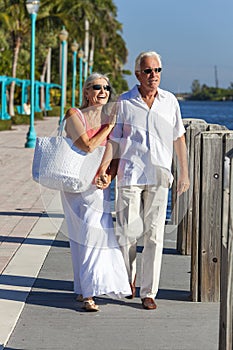 Happy Senior Couple Walking Tropical Sea or River