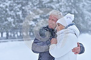 Happy senior couple walking at winter outdoors