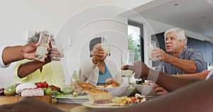 Happy senior diverse people having dinner at retirement home