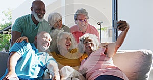 Happy senior diverse people taking selfie at retirement home