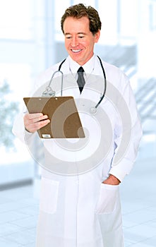 Happy Senior Doctor Looking At Report In Hospital