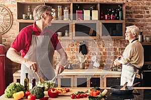 Happy Senior Family Spending Time Together In Kitchen, Cooking Dinner