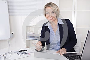 Happy senior female manager - portrait in the office.