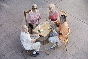 Happy Senior Friends Playing Cards