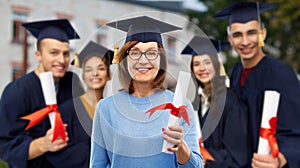 Happy senior graduate student woman with diploma