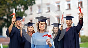 Happy senior graduate student woman with diploma