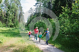 happy senior grandmother with kids walk in nature