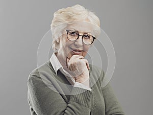 Happy senior lady posing on gray background