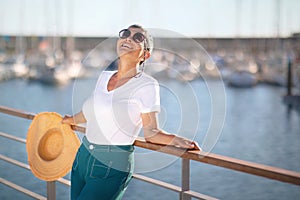 Happy Senior Lady Posing At Sea Promenade Near Marina Dock