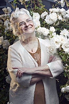 Happy senior lady in the rose garden