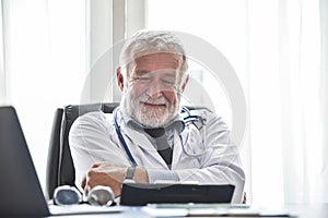 Happy Senior male Doctor is thinking.