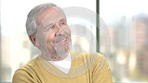 Happy senior man on blurred background.