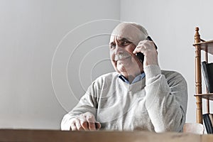 Happy senior man chatting on his mobile phone