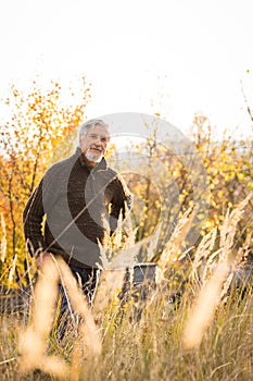 Happy senior man enjoying a lovele autumn day