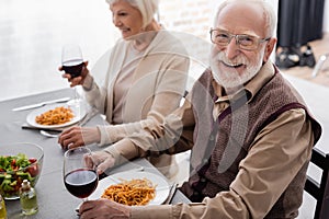 happy senior man in eyeglasses smiling