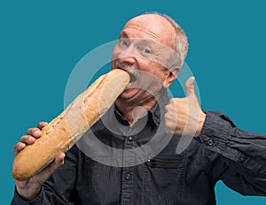 Happy senior man with fresh baguette