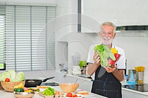 Happy senior man in kitchen