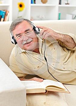 Happy senior man listening to music