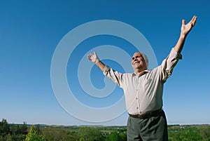 Happy senior man rejoicing in nature photo