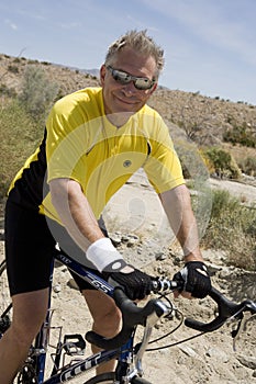 Happy Senior Man Riding Bicycle