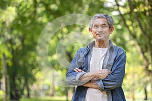 happy senior man smile while standing in the forest park