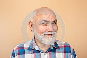 Happy senior man smiling. Older grandfather, grandpa pensioner, retiree concept. Mature bald man with grey beard on