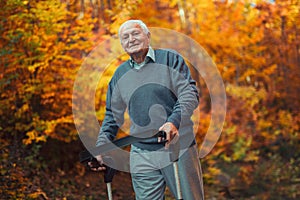 Happy senior man with a walking in park