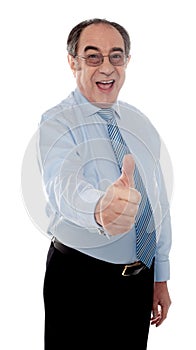 Happy senior manager posing with thumbs-up gesture