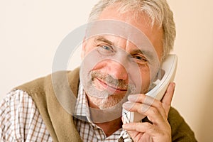 Happy senior mature man on the phone