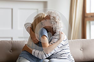 Happy senior mom and adult daughter reconcile after fight