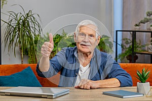 Happy senior old man looking approvingly at camera showing thumbs up like positive sign good news