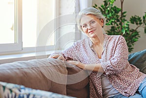 Happy senior old woman smiling at home