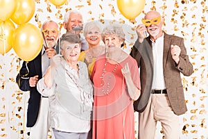 Happy senior people celebrating and having fun together