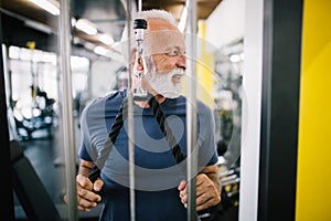 Happy senior people doing exercises in gym to stay fit