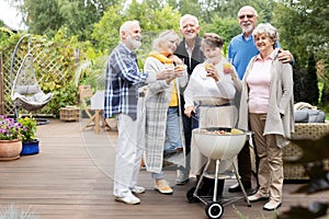 Happy senior people during garden party