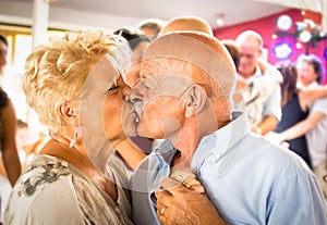 Happy senior retired couple having fun on dancing at restaurant